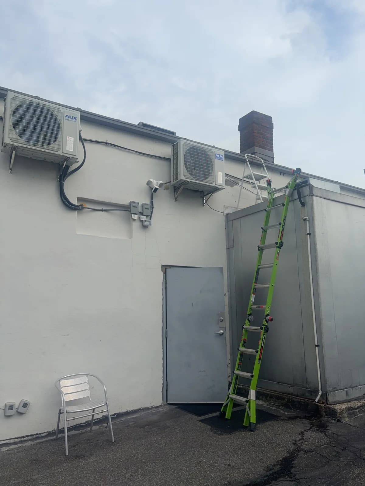 Outdoor heat pump units mounted on the exterior wall at Wally’s project.