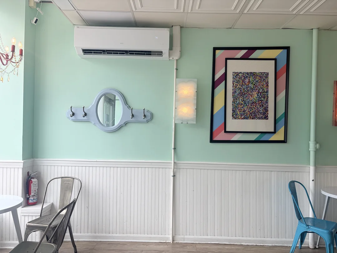 Wall-mounted indoor heat pump above the window-side seating at Wally’s.